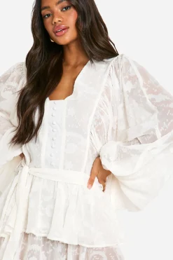 Robe patineuse à étages en jacquard floral ceinturée