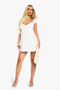 Robe smock en broderie anglaise à manches cap
