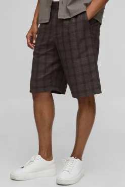 Shorts longs à carreaux, coupe ample avec taille élastiquée.