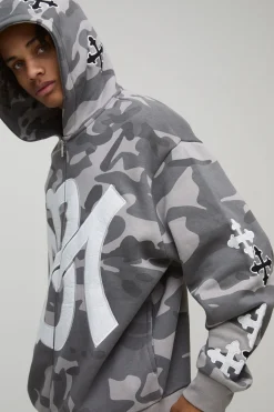 Sweat à capuche oversize à appliqué croisé camouflage avec zip intégral