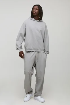 Sweat à capuche oversize, coupe boxy, en maille loopback avec inscription "MAN" en script, brodé et panneau côtelé