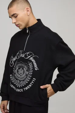 Sweat-shirt oversize, coupe boxy, style universitaire, col entonnoir et fermeture éclair quarter zip.