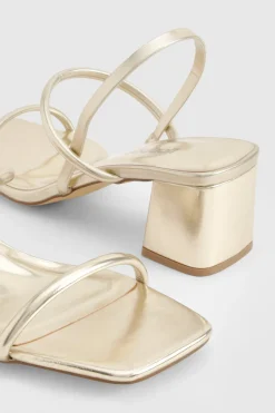 Talons compensés métalliques à bride arrière pour pieds larges