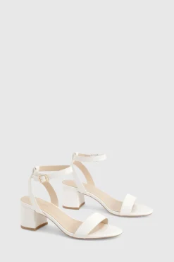 Talons à large coupe, bloc bas, à peine perceptibles