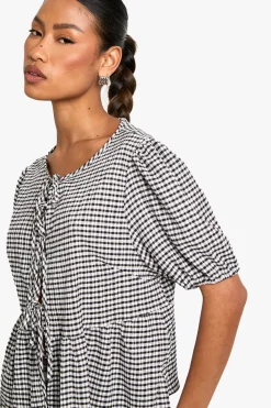 Top smock en gingham avec nœud à l'avant et manches bouffantes