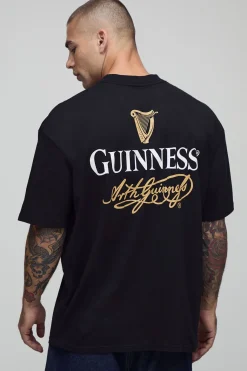 T-shirt noir surdimensionné à col étendu imprimé sous licence Guinness