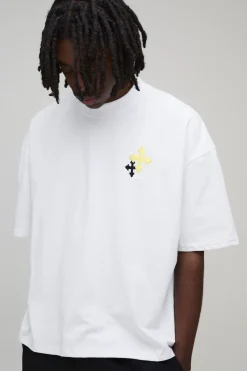 T-shirt oversize à la coupe boxy et orné d'une broderie en croix