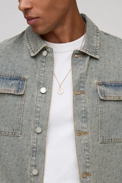 Veste en denim lavé à monogramme, surdimensionnée et à coupe carrée