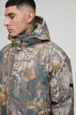 Veste matelassée longue, surdimensionnée, à capuche avec col entonnoir en camouflage forêt