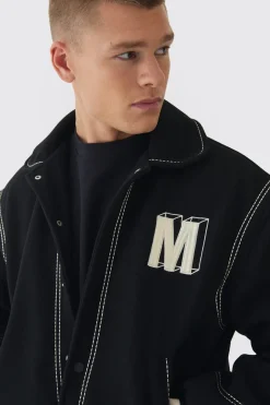 Veste Varsity en melton noire à coupe boxy avec détails de surpiqûres